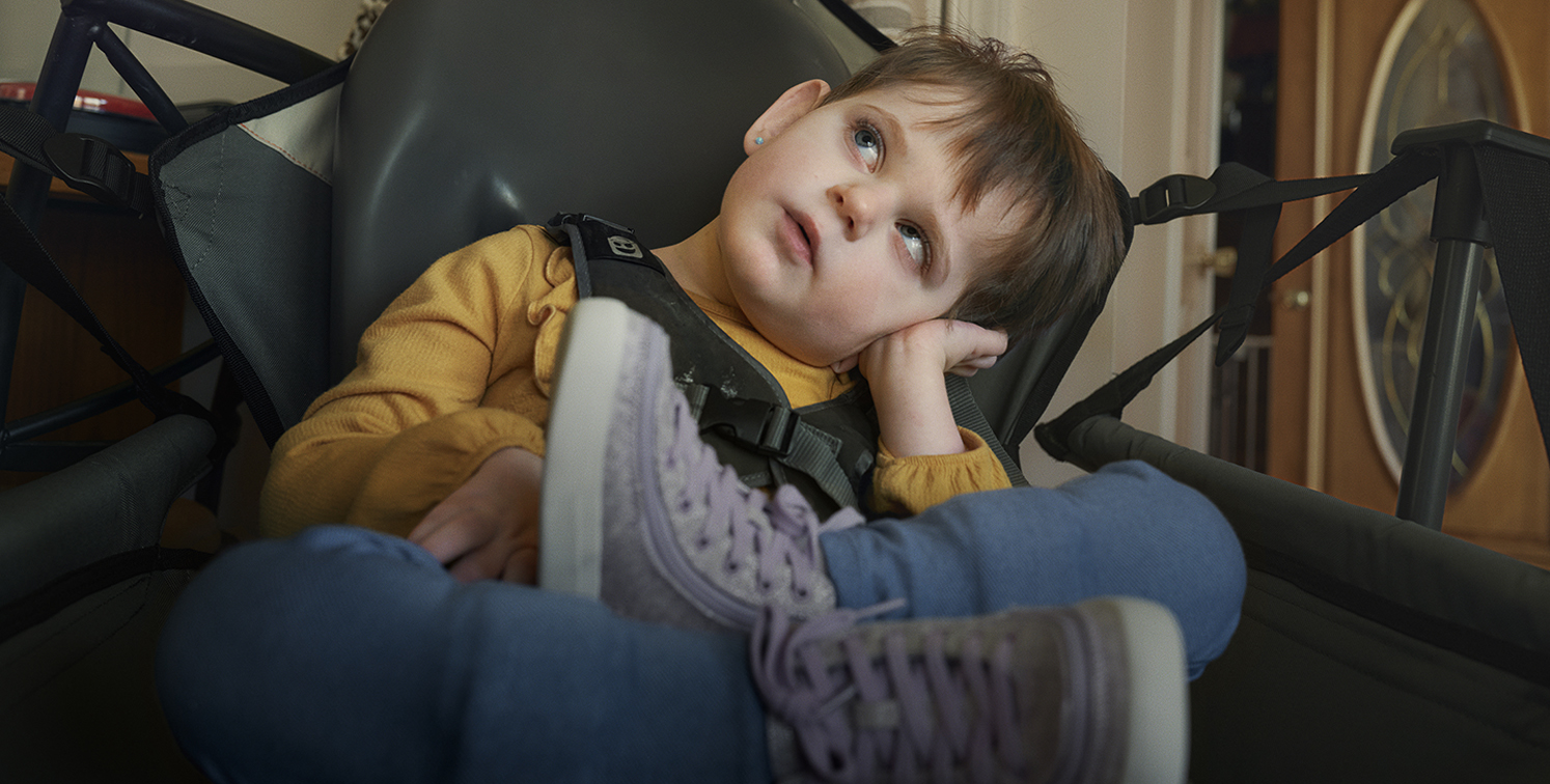 Girl sitting in a chair and looking up